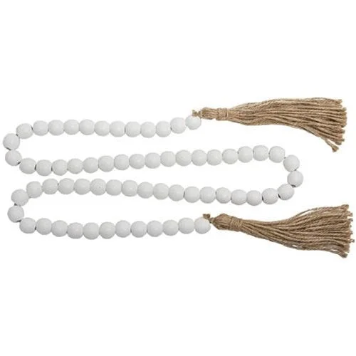 Bed skirts with a tropical print for a vacation - inspired feelWhite Beaded Garland with Tassels 48"L